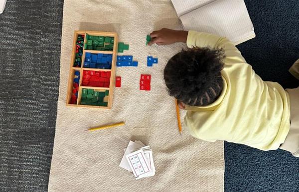 student doing montessori math
